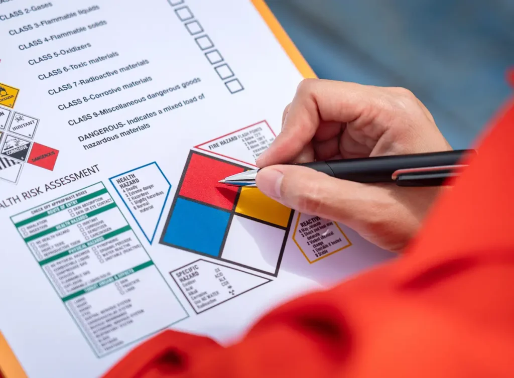 A safety consultant conducting an inspection in an industrial setting, checking safety protocols and equipment. - Central IL