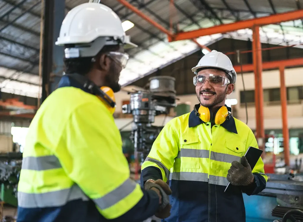 Retained Safety Professional shaking hands with an industrial worker - central il